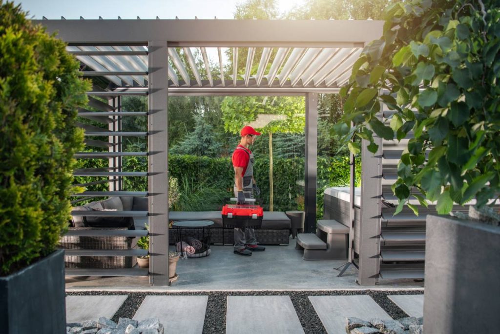 Caucasian Hot Tub Residential Spa Technician with Tools Box in His Hand Preparing For Scheduled Jacuzzi Maintenance Inside the