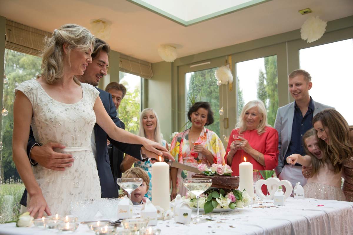 Newlyweds cutting wedding cake at reception