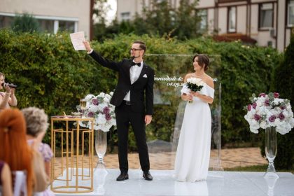 wedding ceremony of the newlyweds on the glade near the restaurant